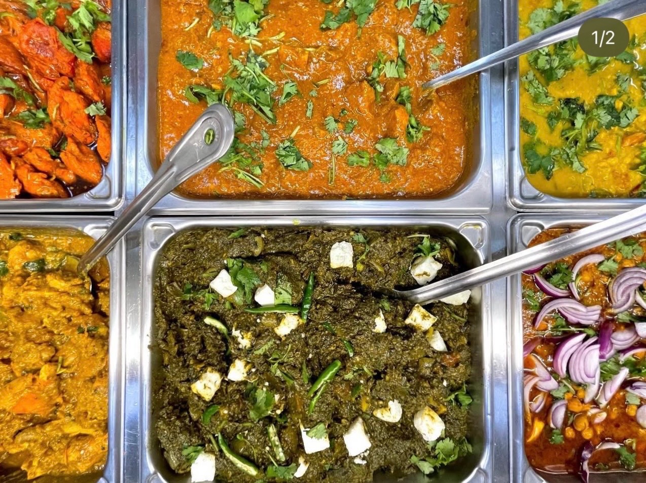 Variety of fresh hot food available to-go at International Foods & Spices